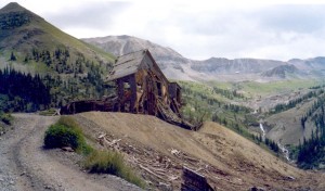 A snapshot from my parents' album showing Tomboy Mines in the 1970s, with the 13,114-foot Imogene Pass summit in the background.
