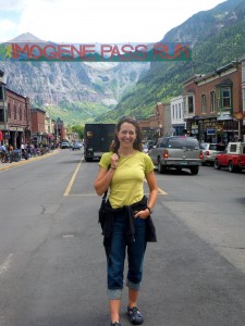 Standing under the race banner on Telluride's main street, Colorado Avenue, the day before the race. The summit we cross during the race is hiding behind the ridge that's behind the "I" in "Imogene" on the banner.
